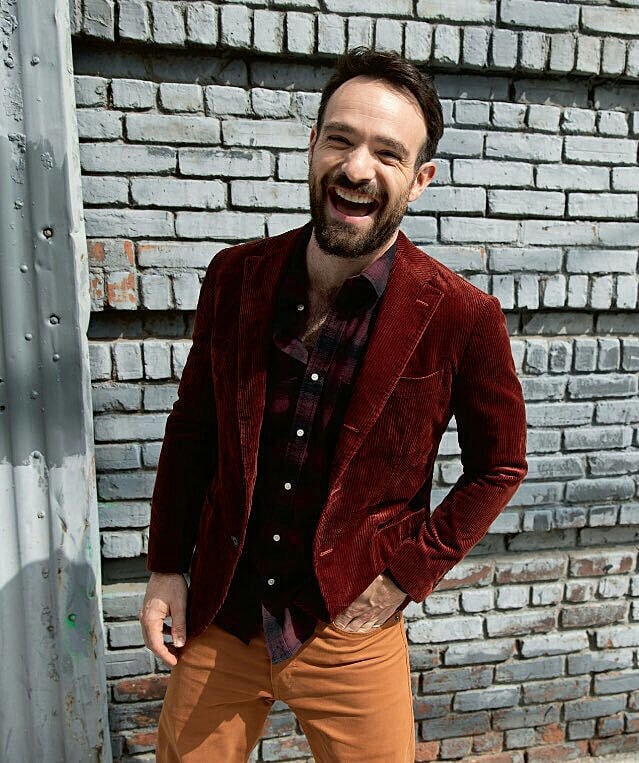 Charlie Cox laughs while posing for a picture